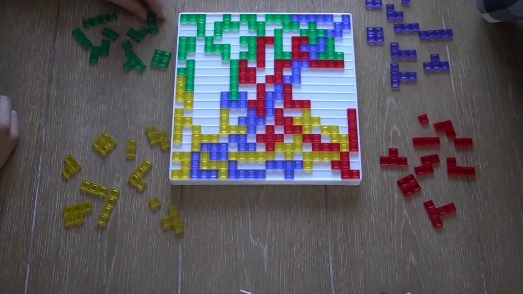 Blokus board game with green, purple, red, and yellow pieces in play