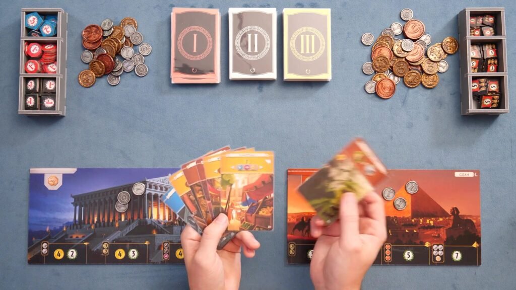 7 Wonders board game components including coins, cards, and player boards.