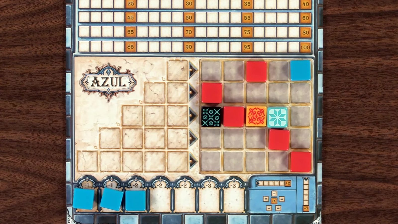 Player placing a red tile on their Azul board.