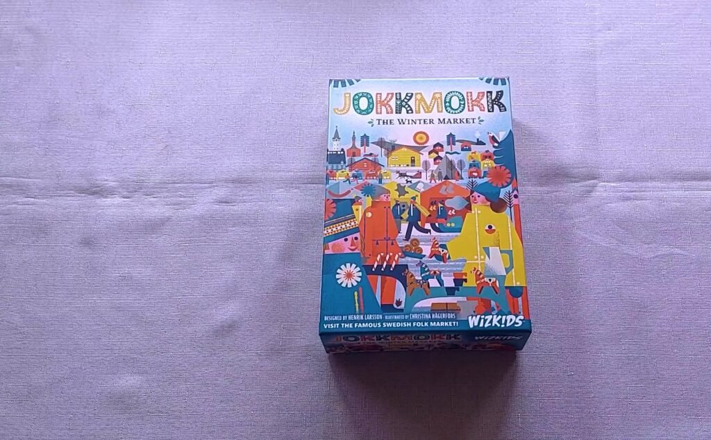 Jokkmokk: The Winter Market card game box featuring a colorful illustration of a bustling winter market scene.