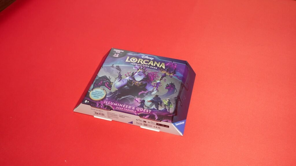 Disney Lorcana Trading Card Game: Illumineer's Odyssey Deep Trouble box on a red background
