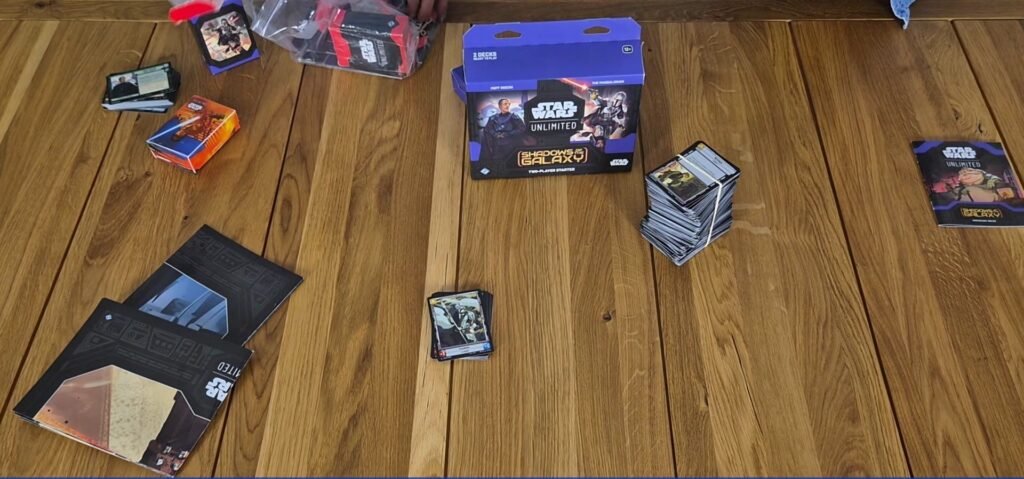 Star Wars Unlimited card game components and box on a wooden table